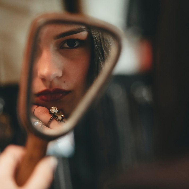 Iowa City Therapist: a woman looking at herself through a mirror