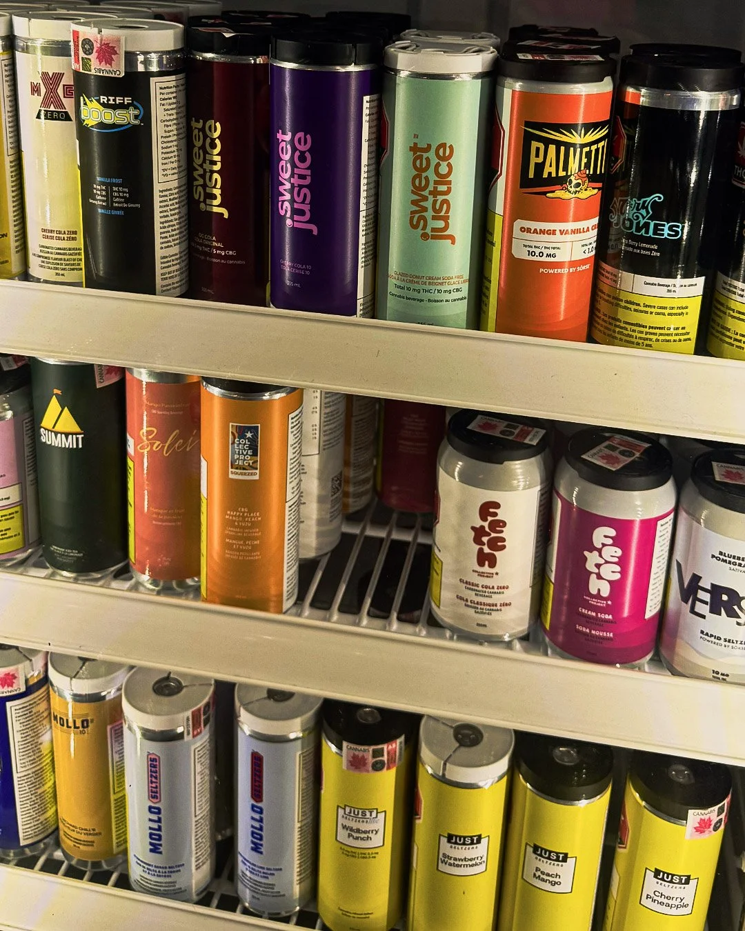 Shelves stocked with cans and bottles of flavored cannabis beverages