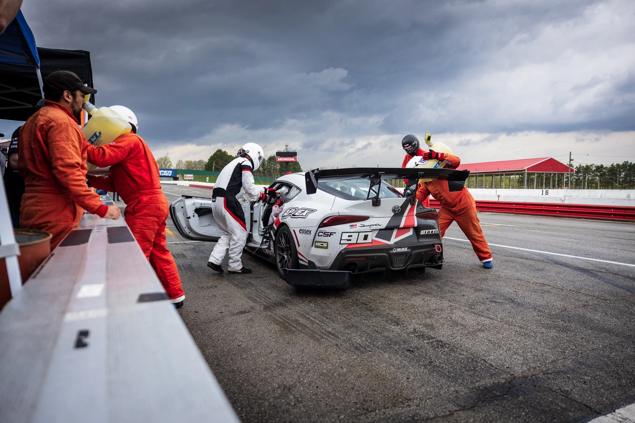 Toyota R&D Racing crew changing drivers and refueling the number 90 A90 Supra in Mid-Ohio pit lane.
