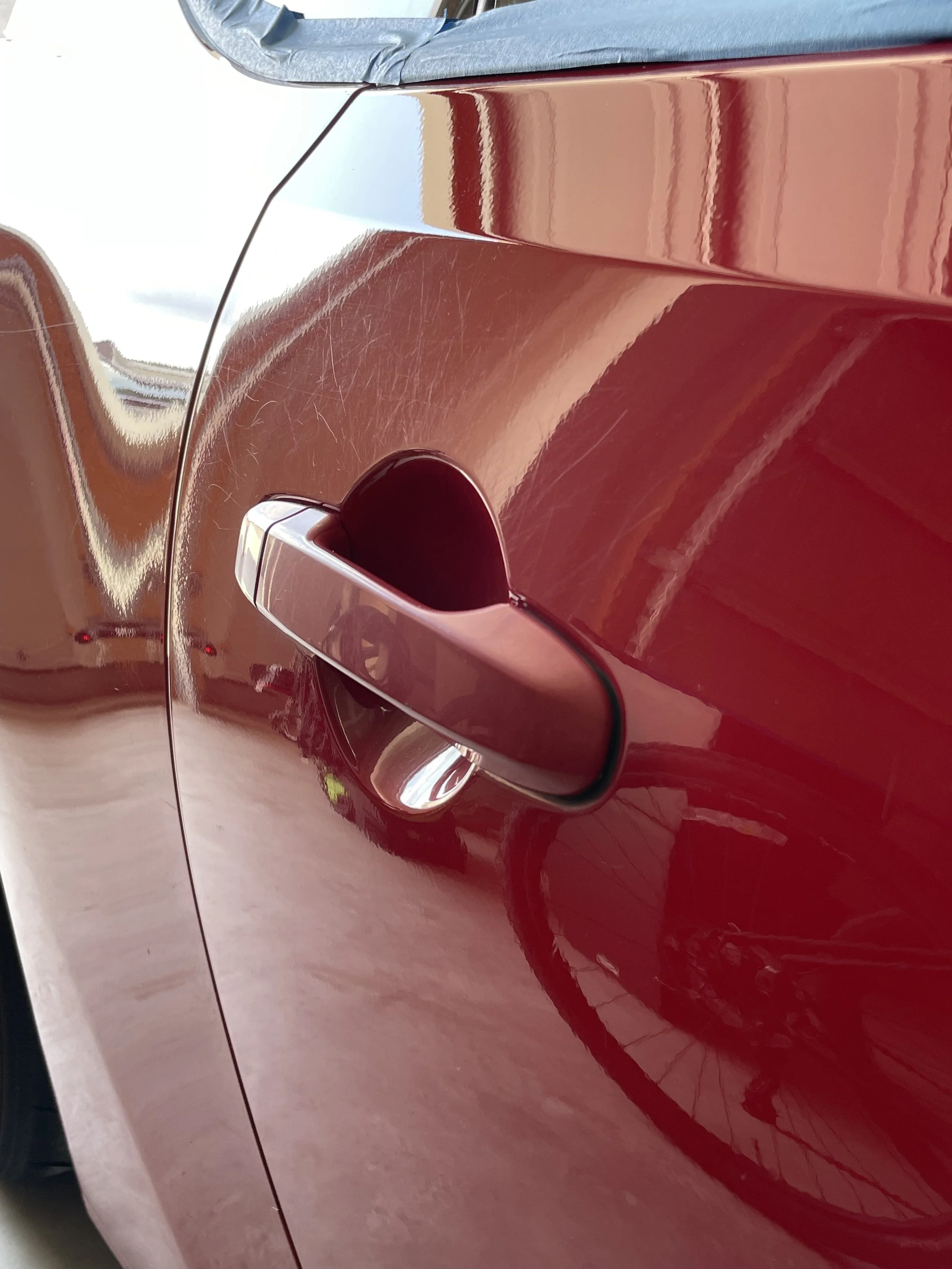 Close-up of the red FR-S door handle and reflections along the side panel.