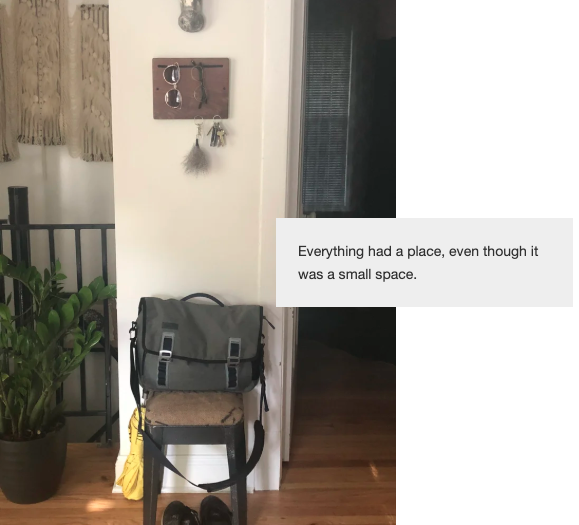 A stool with a bag on top, shoes underneath and an umbrella leaning against it. Above it is an organizer to hang keys and glasses.