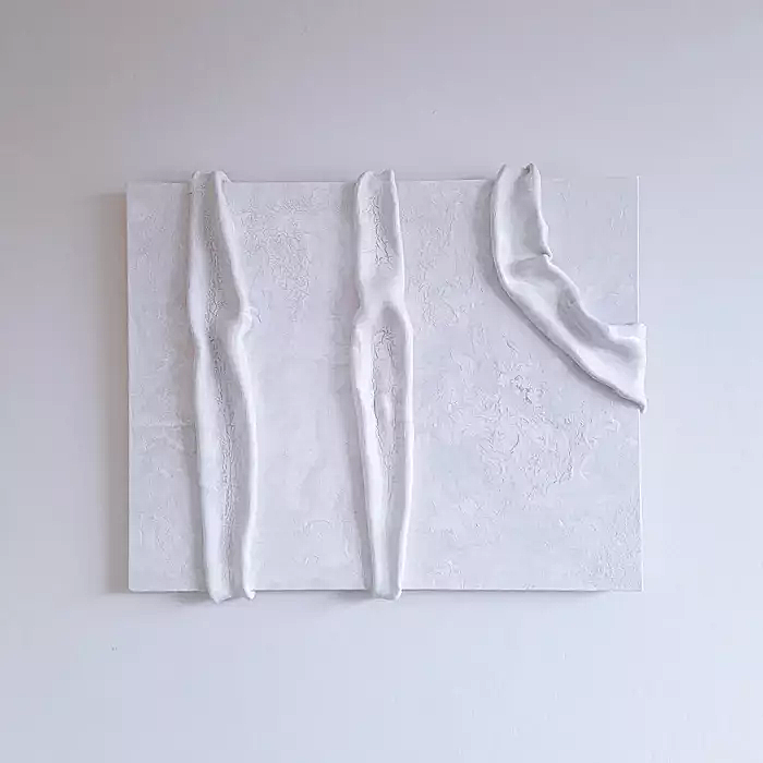 Abstract white textured art piece with three vertical wavy lines and a curved shape on a white background.