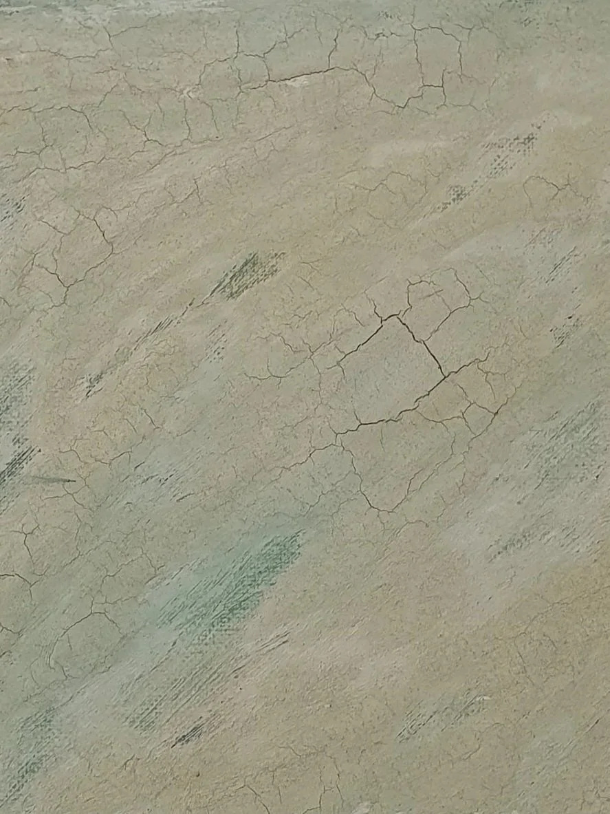 Close-up of a painting with peeling, cracked light green paint and some visible brush strokes.