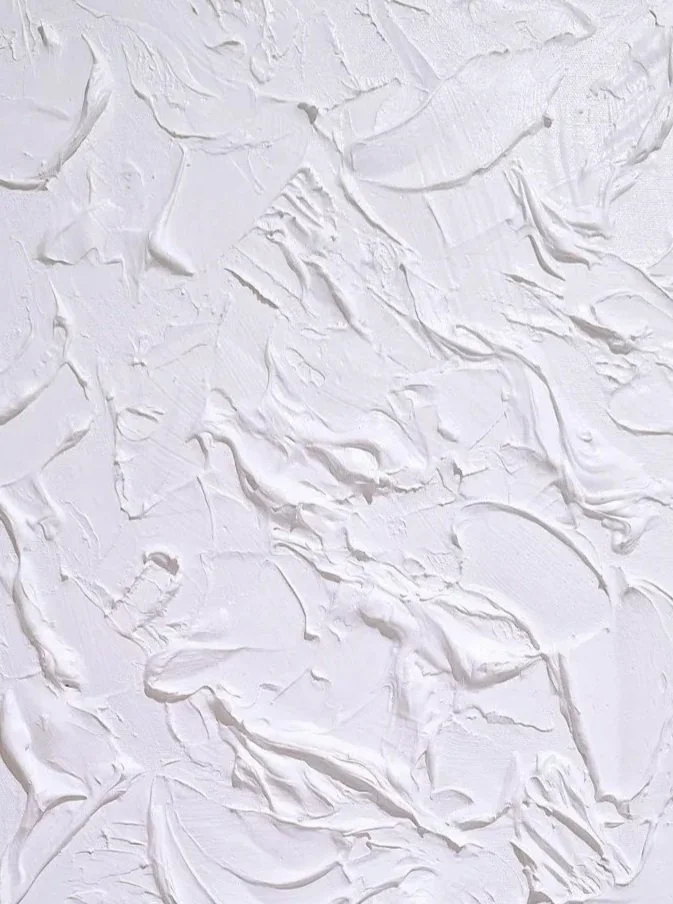 Abstract textured white paint surface with thick brush strokes and ridges.