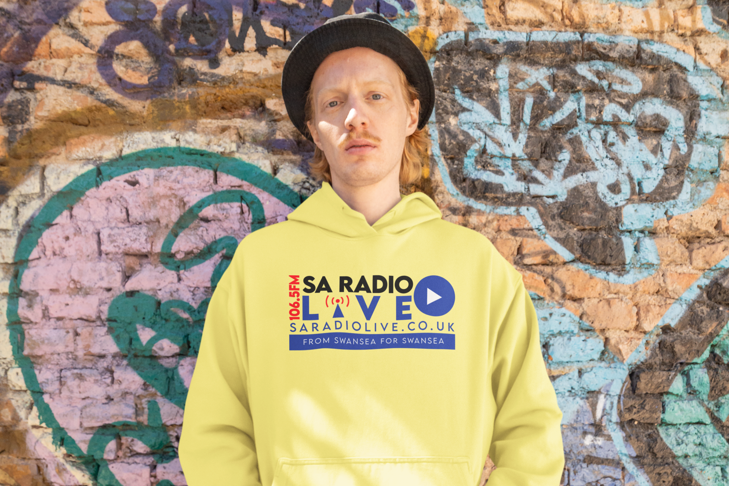 hip-hop-inspired-mockup-of-a-man-wearing-a-hoodie-in-front-of-a-graffiti-wall-m40016.png