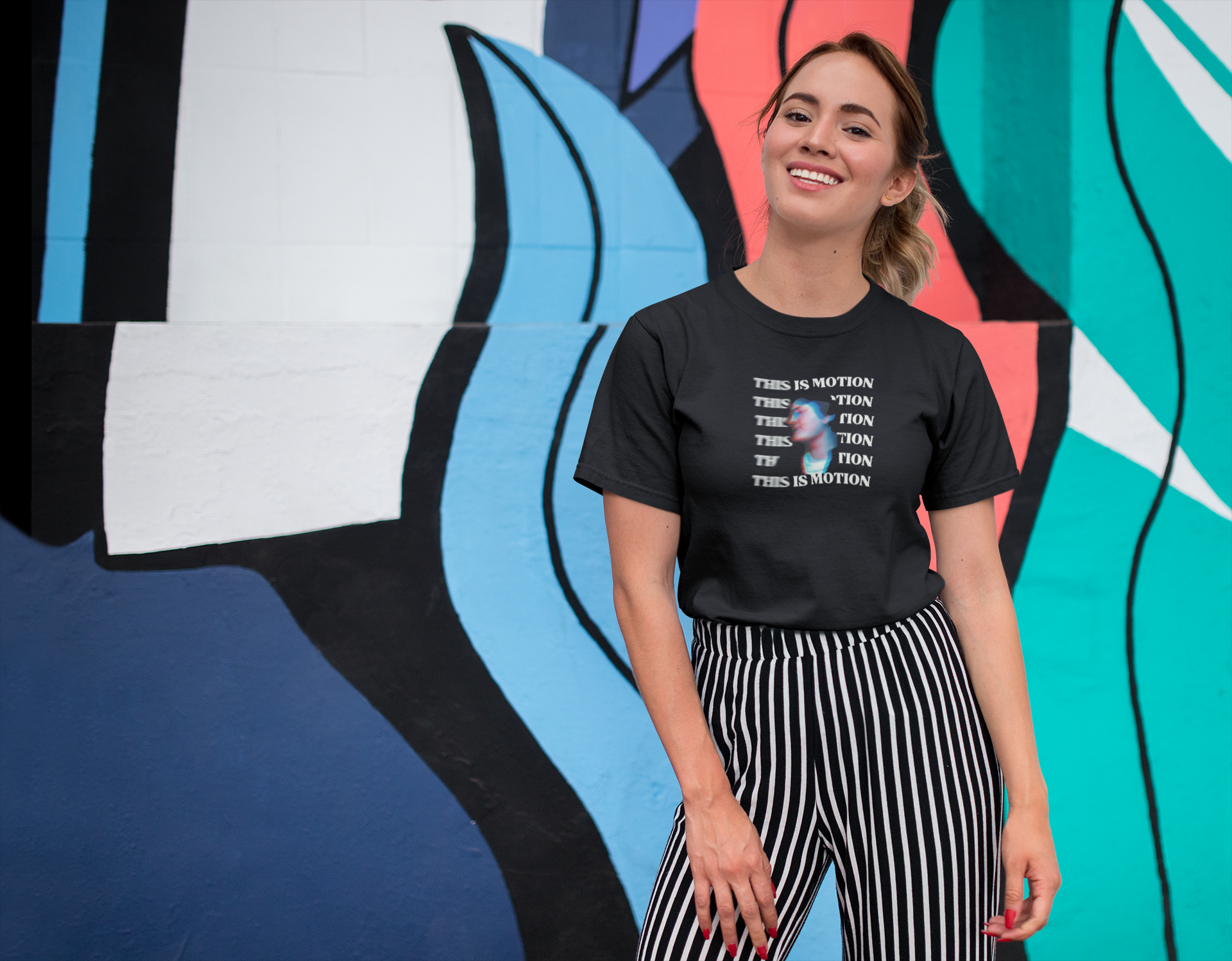 tee-mockup-of-a-smiling-girl-in-front-of-a-wall-with-colorful-illustrations-26646-2.png