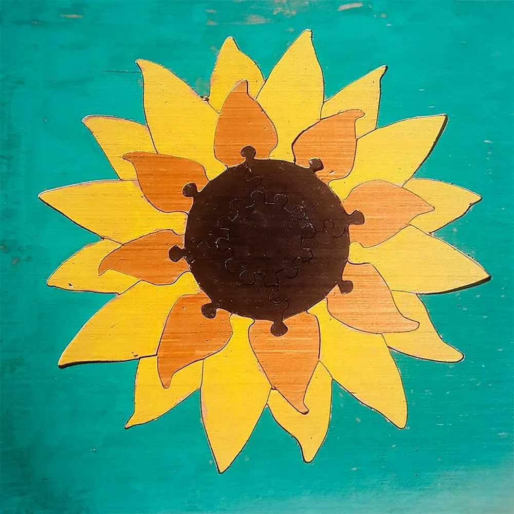 A wooden sunflower puzzle created by Tom Lowe