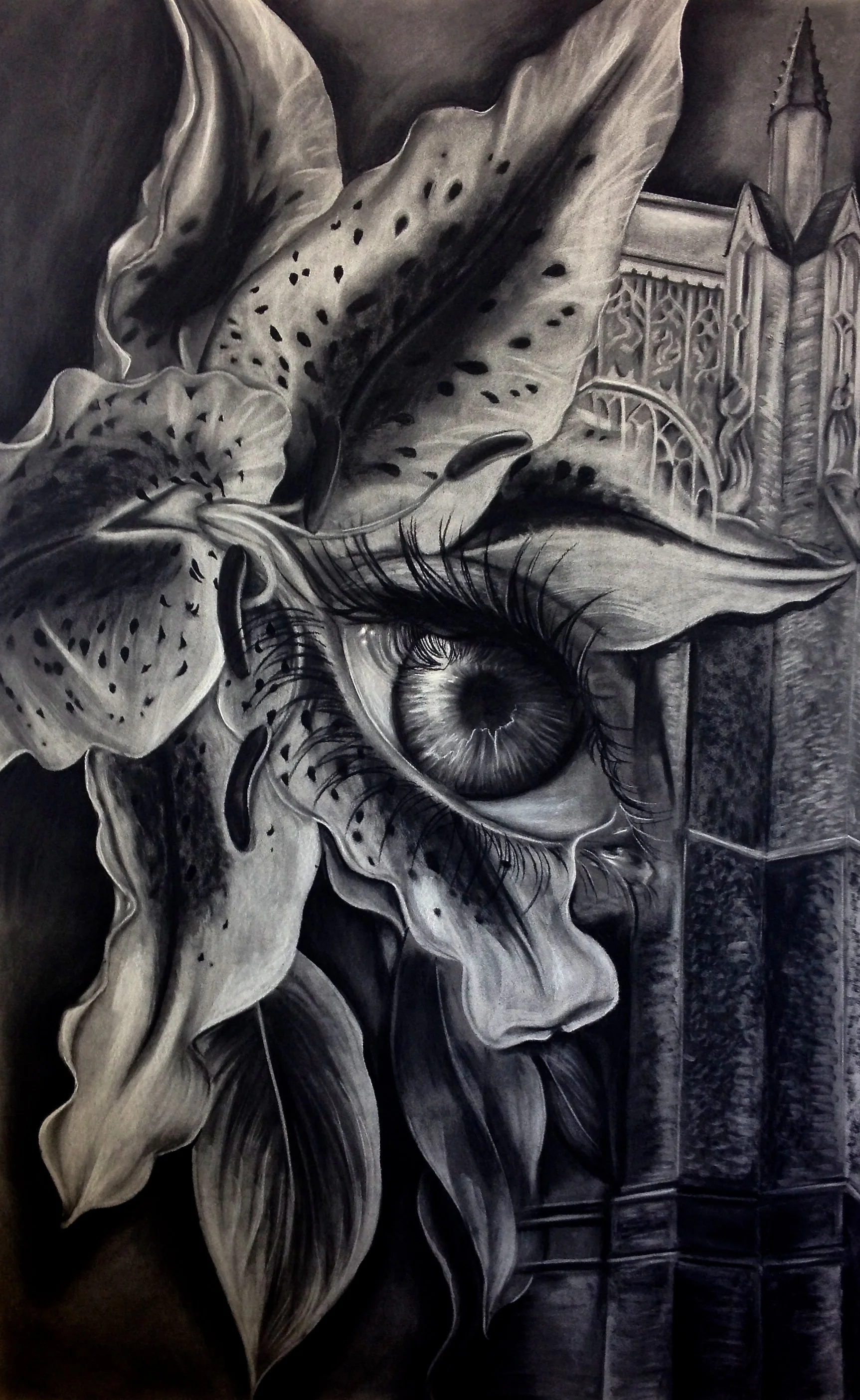 A black and white mural of a human face with an eye and eyelashes, surrounded by large leaves and a Gothic-style architectural background. By Nicole Vanner.