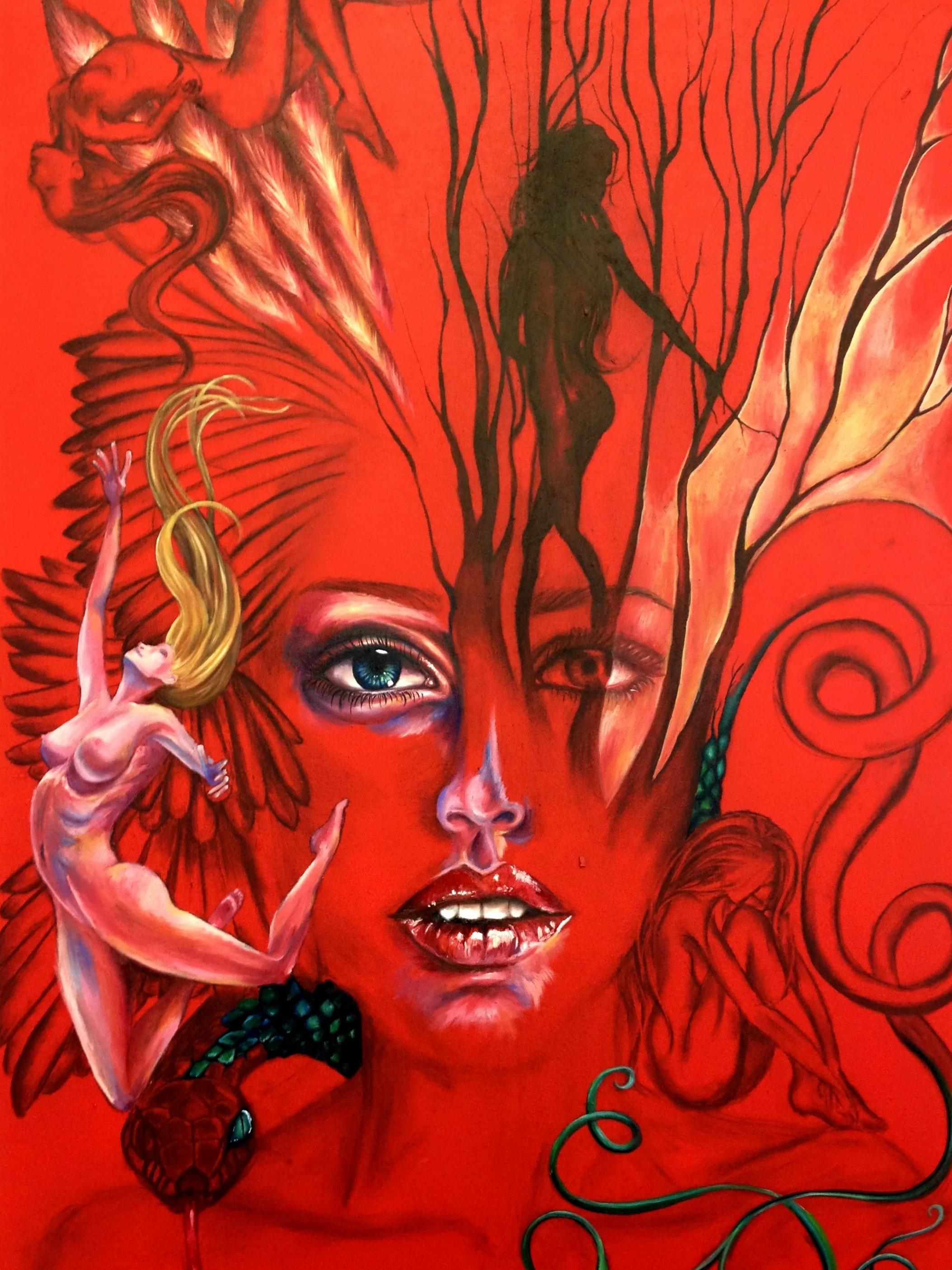 Colorful mural depicting a woman’s face with street art elements, including a dragon, a snake, an angelic figure, and a silhouette of a woman among tree branches. By Nicole Vanner.