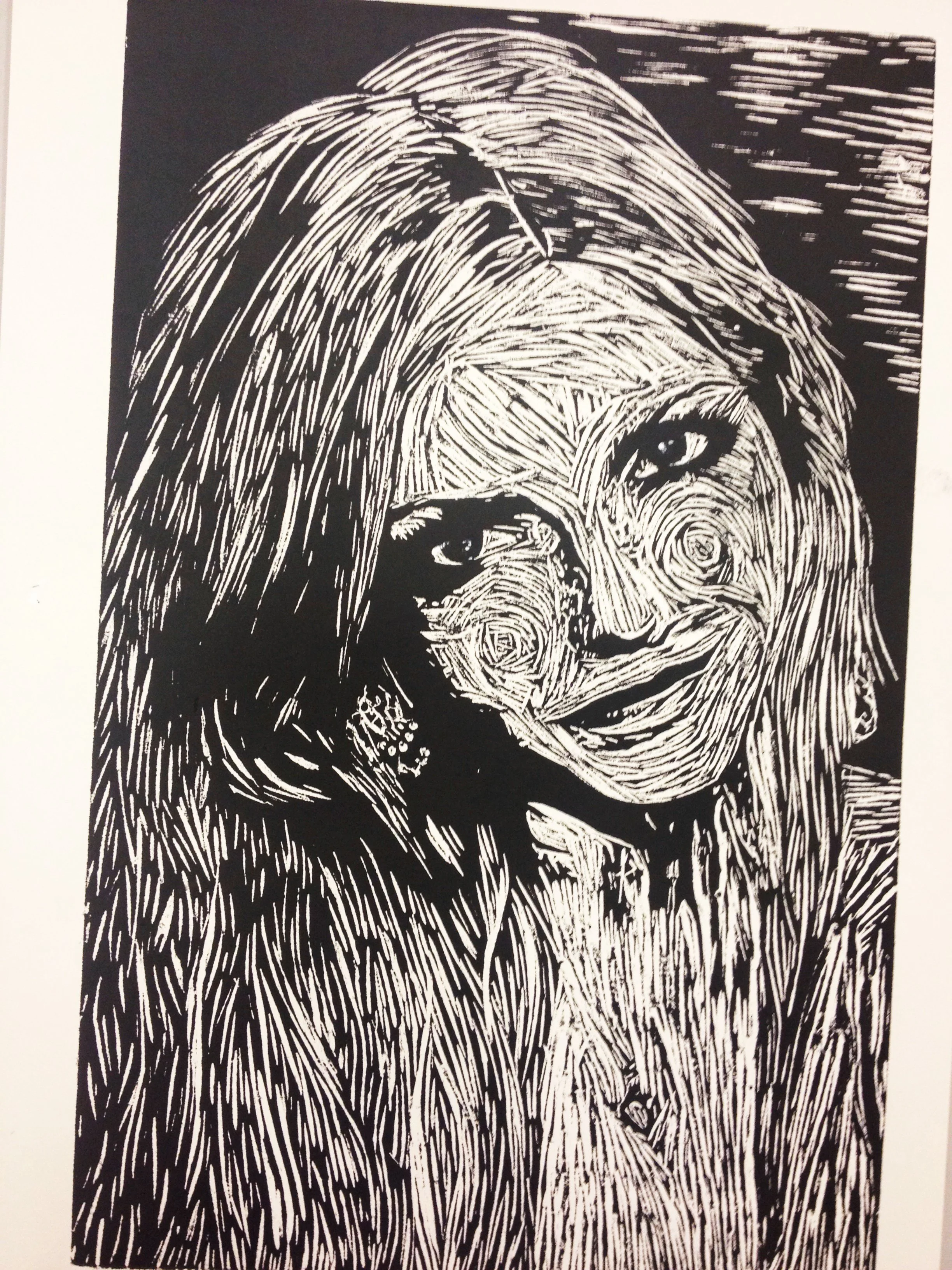 A black and white line drawing of a woman with long hair, smiling and holding a phone to her ear. By Nicole Vanner.