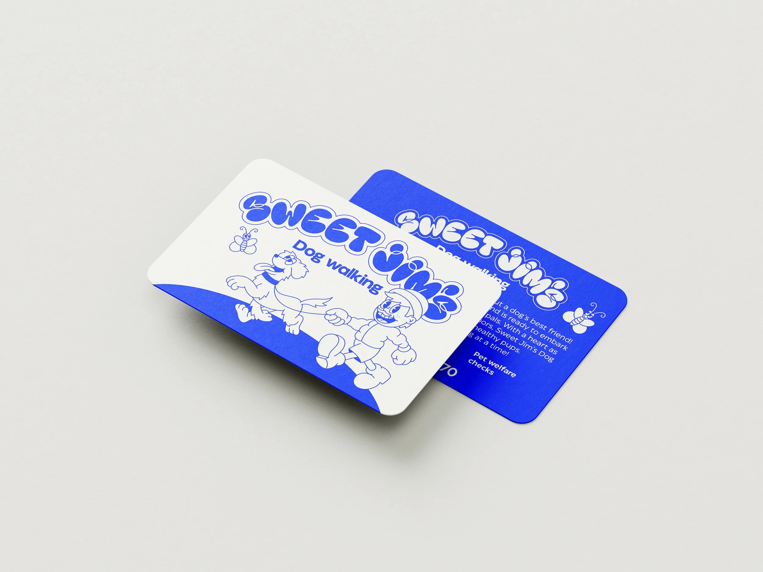 Two blue and white cards with the title 'Sweet Time Dog Walking,' featuring a cartoon dog and a girl, with one card partially overlaying the other on a white surface. By Nicole Vanner.