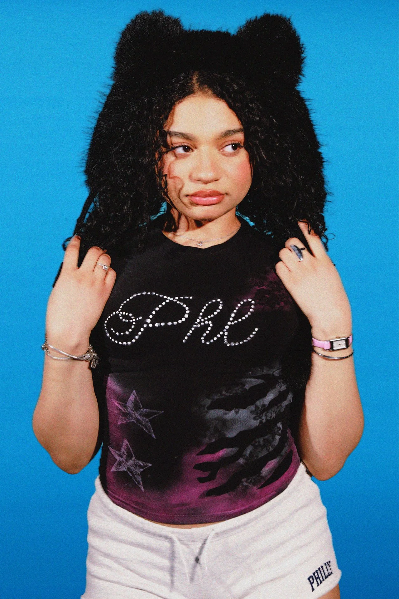 Handpainted white accents embrace the graffiti and art spirit that’s alive in this city, and instantly turn neutral basics into personality pieces