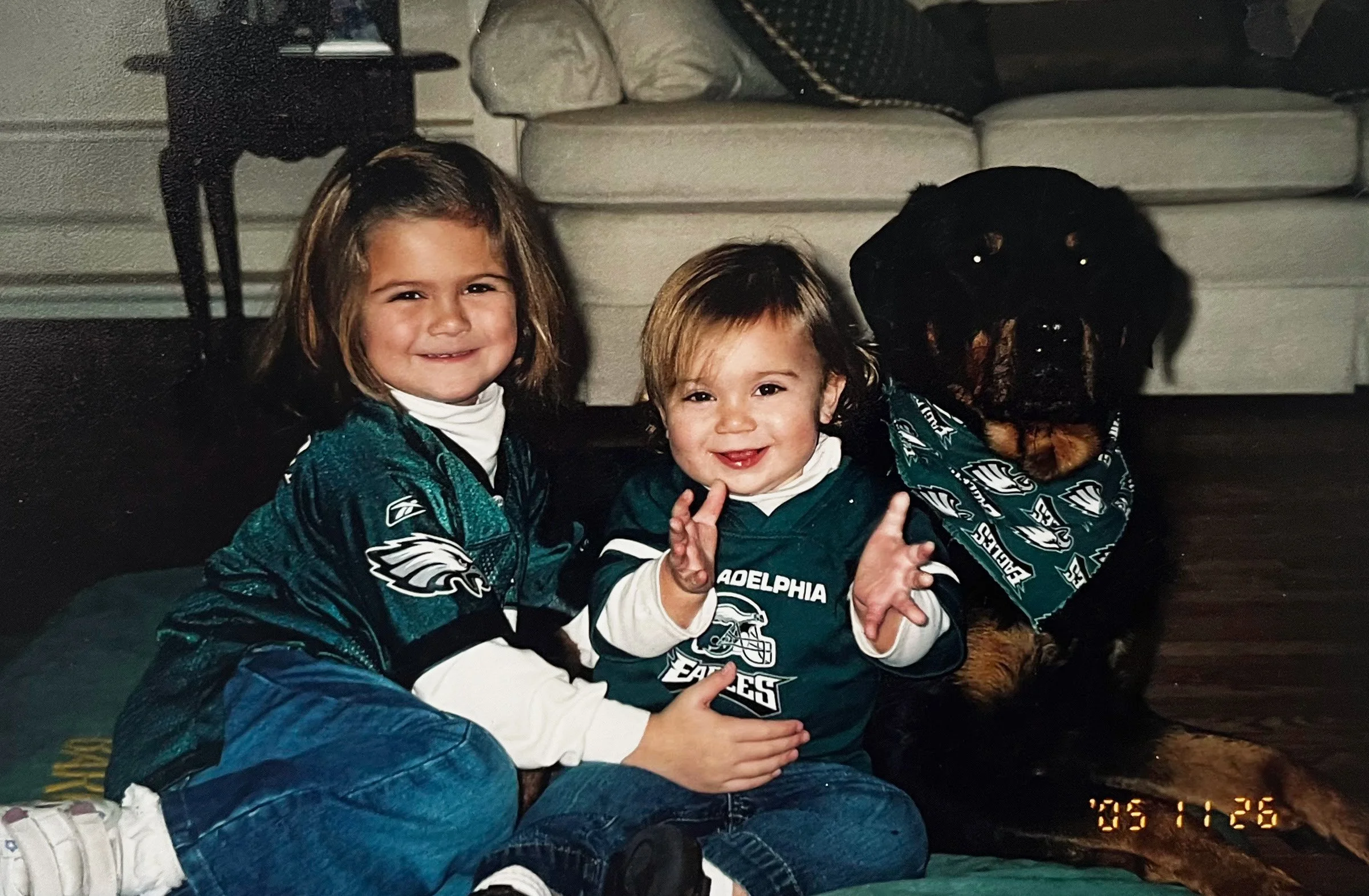 “Two sisters and a dog posing for a photo wearing Philadelphia Eagles jerseys