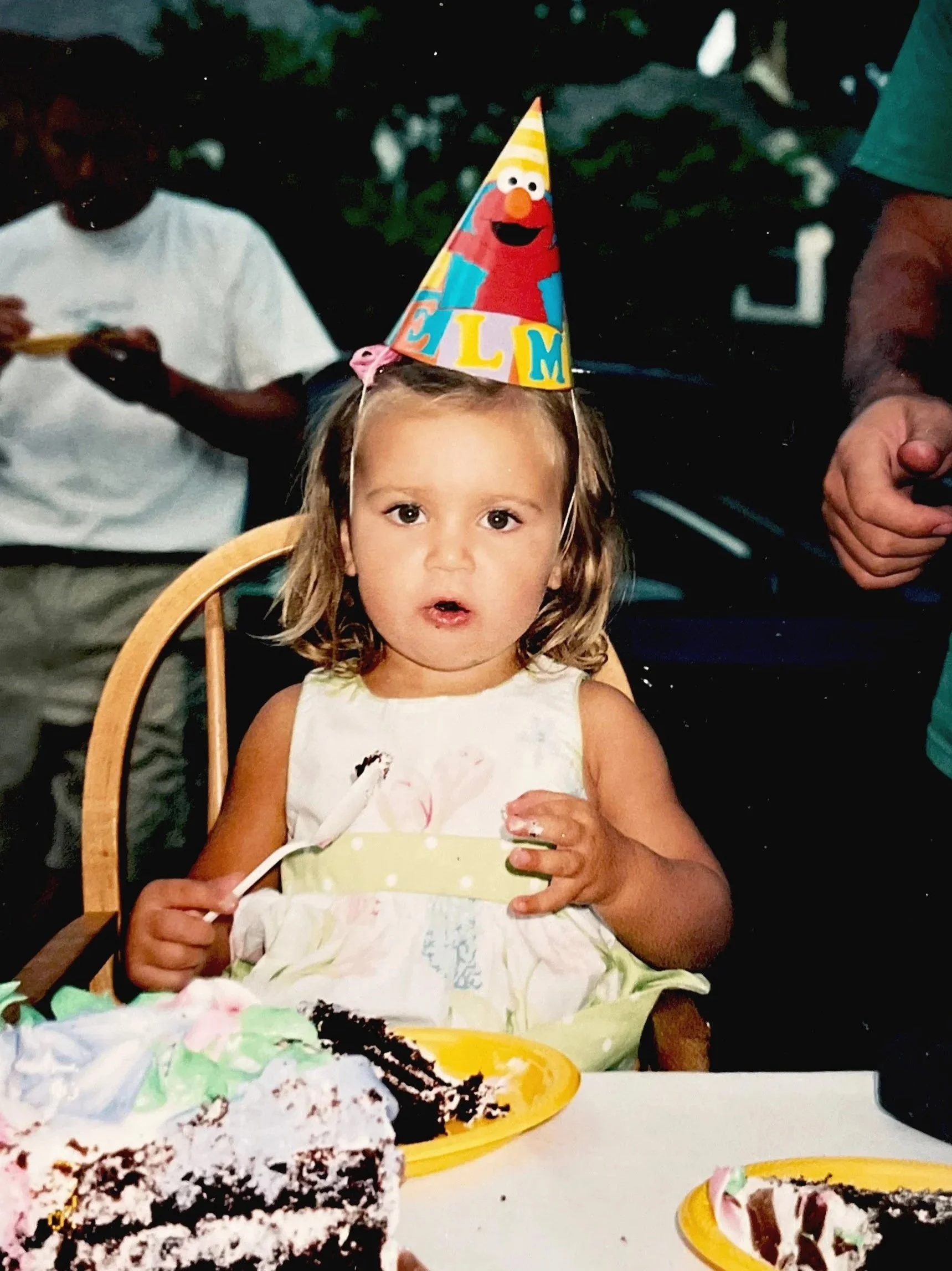 Kaelin celebrating her second birthday, eating chocolate cake