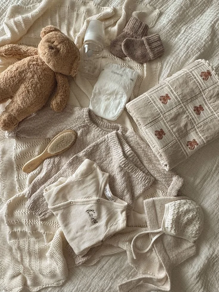 Beige baby clothes, toys, and essentials.