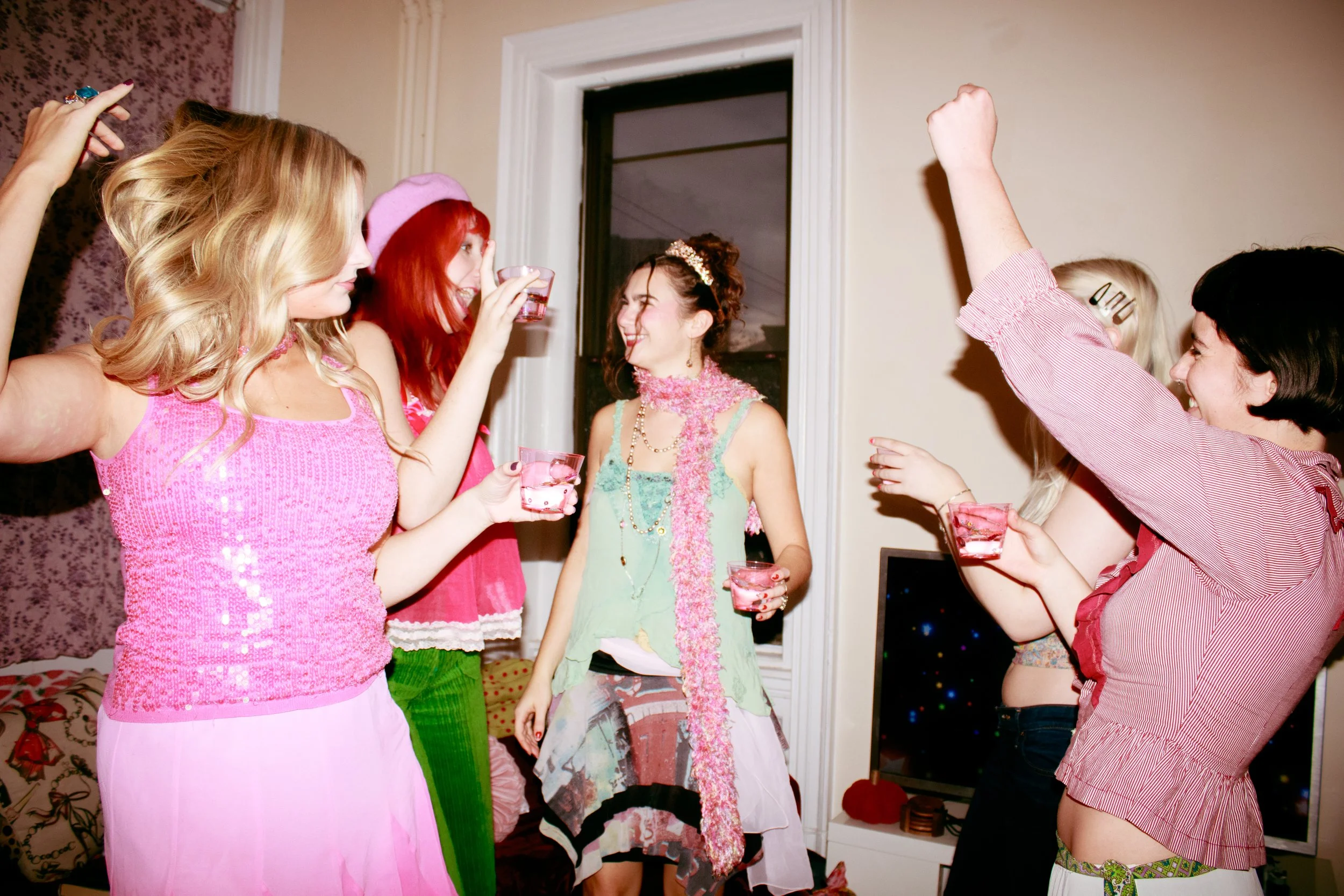  Girls dancing at a nostalgic y2k house party. 