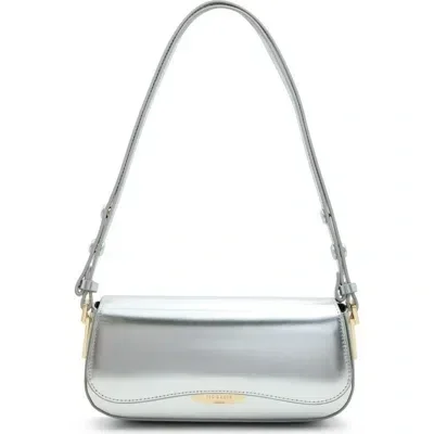  Silver metallic crossbody bag with a slim rectangular shape, flap closure, and adjustable shoulder strap, photographed against a white background.&nbsp; 