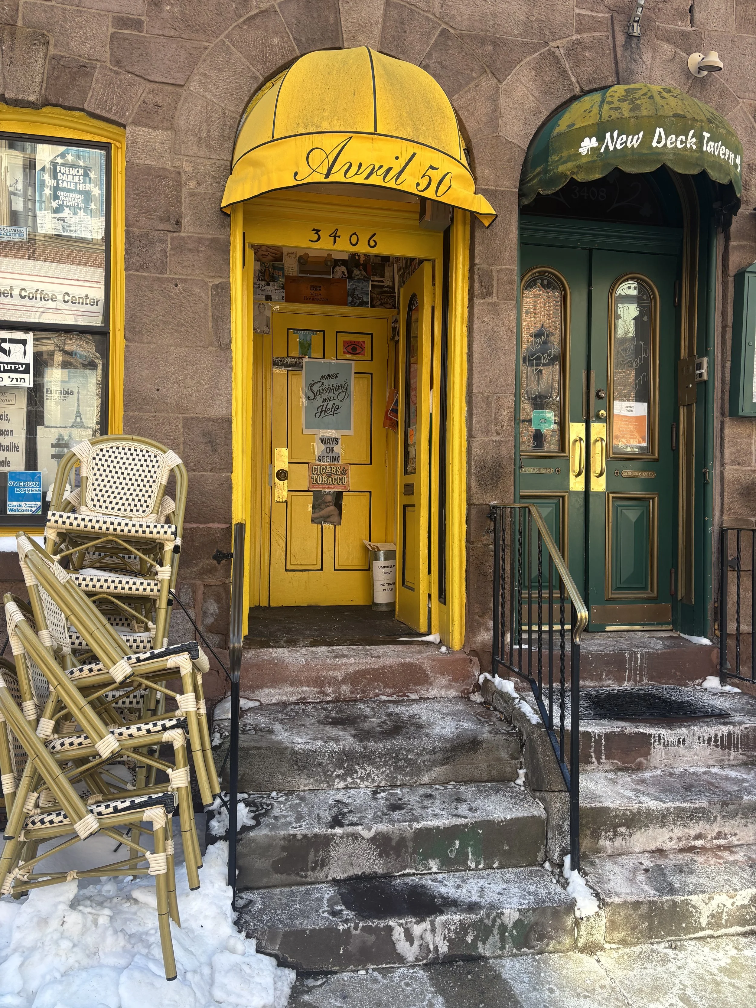 Avril 50 storefront entrance on Sansom Street with yellow awning 