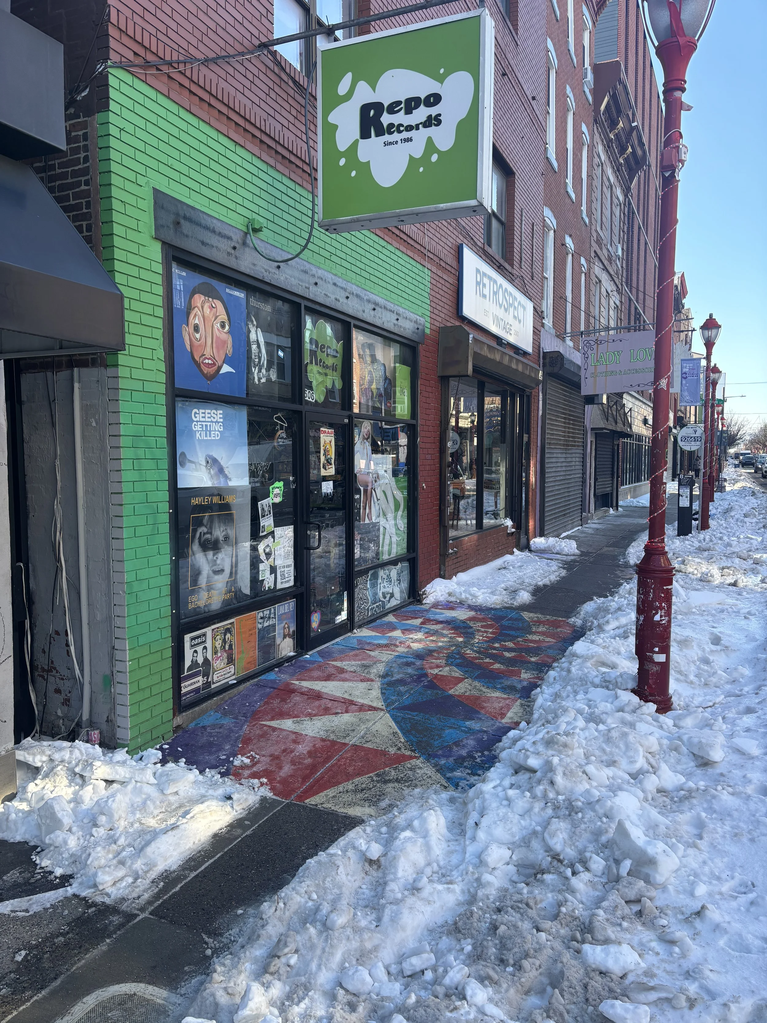  Repo Records storefront on South Street with green sign and sidewalk    