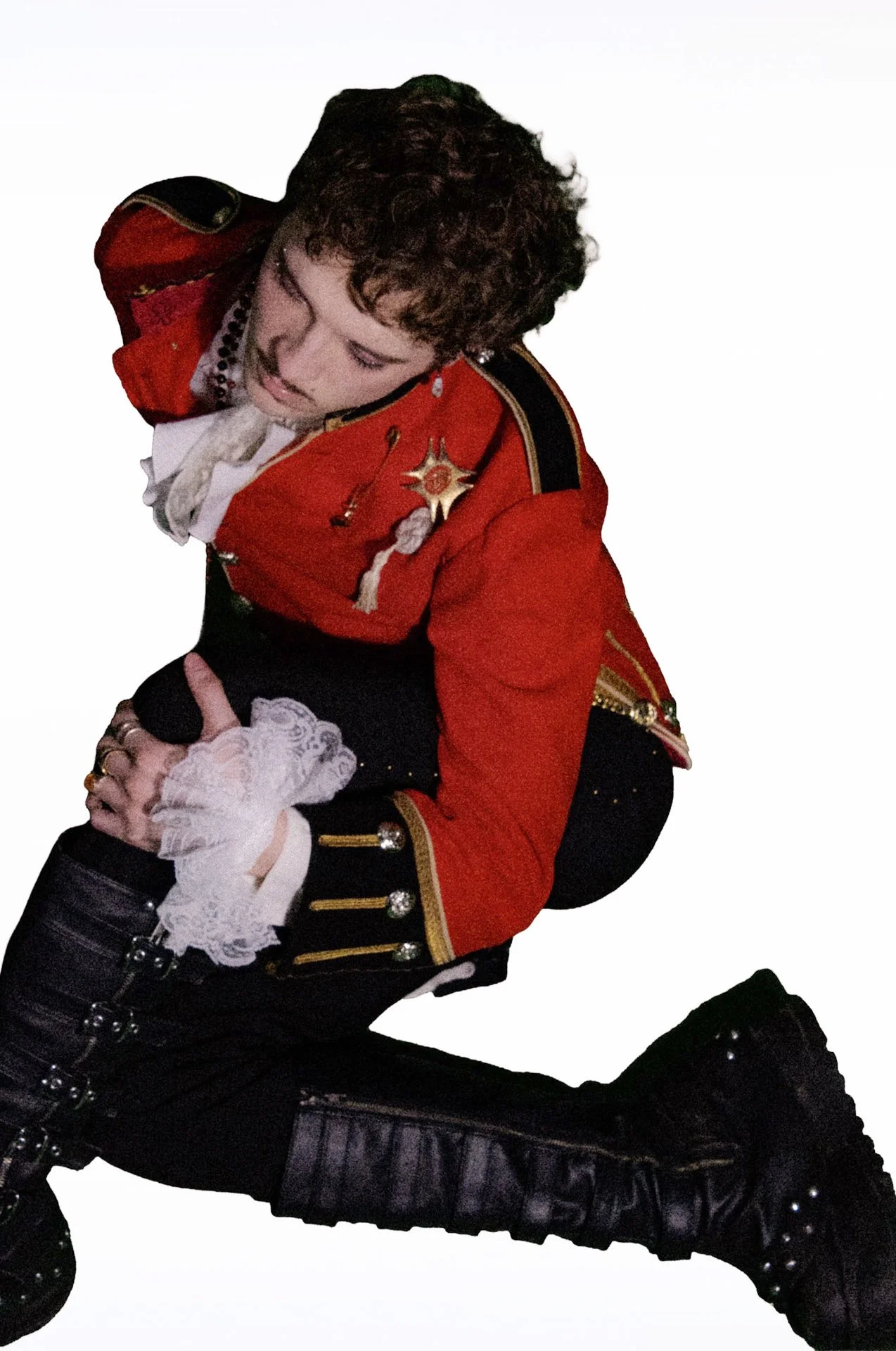 Person in a red military-style jacket posing against a white background.