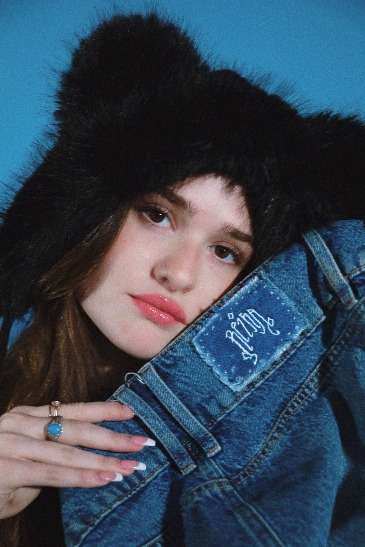 Isabella Butler is the creator of PHL Threads and poses next to her custom tag.