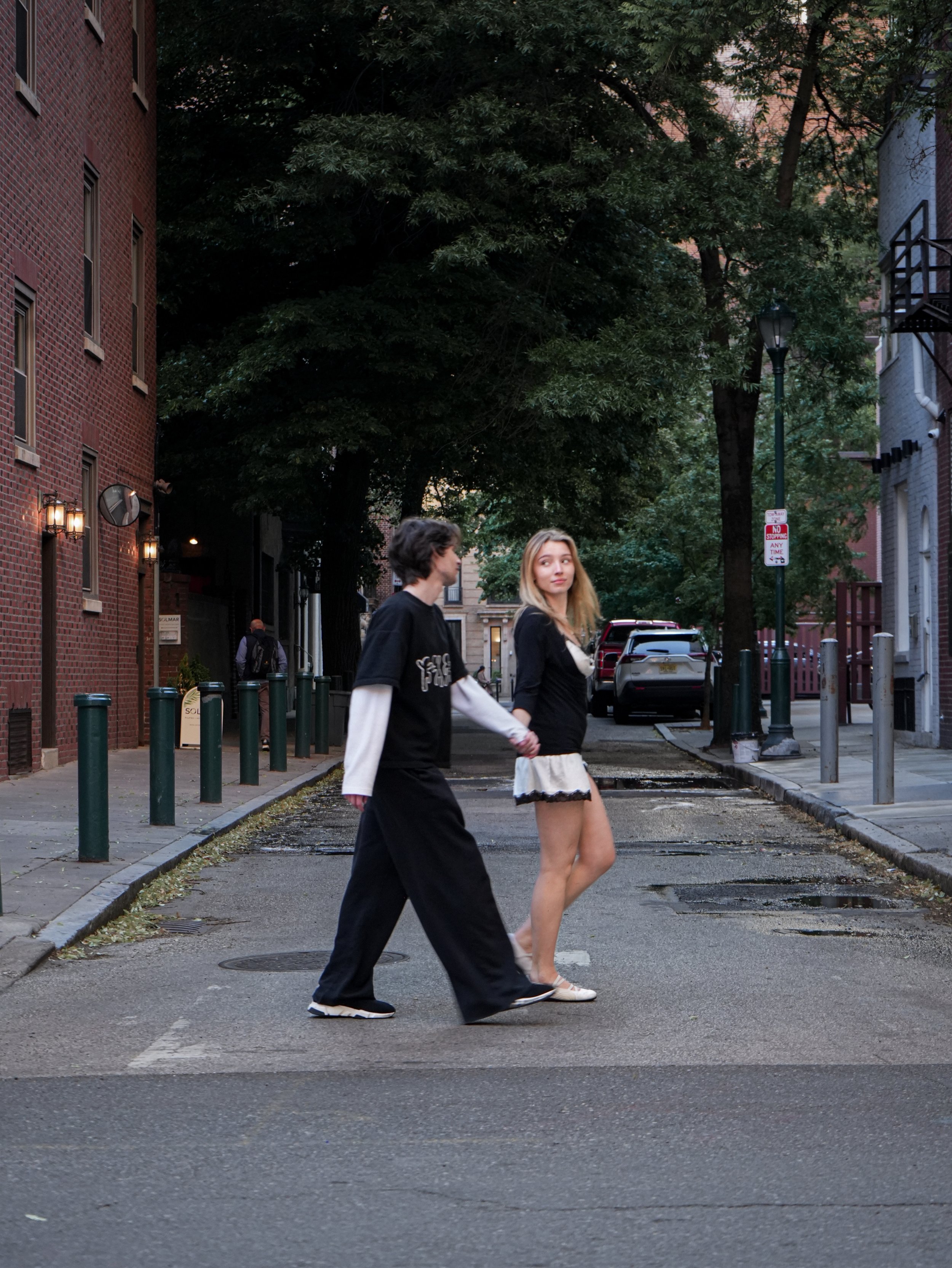 2.	couple-walking-fashion-editorial.jpg; A couple walks down a quiet city street in a cool-toned fashion editorial image.