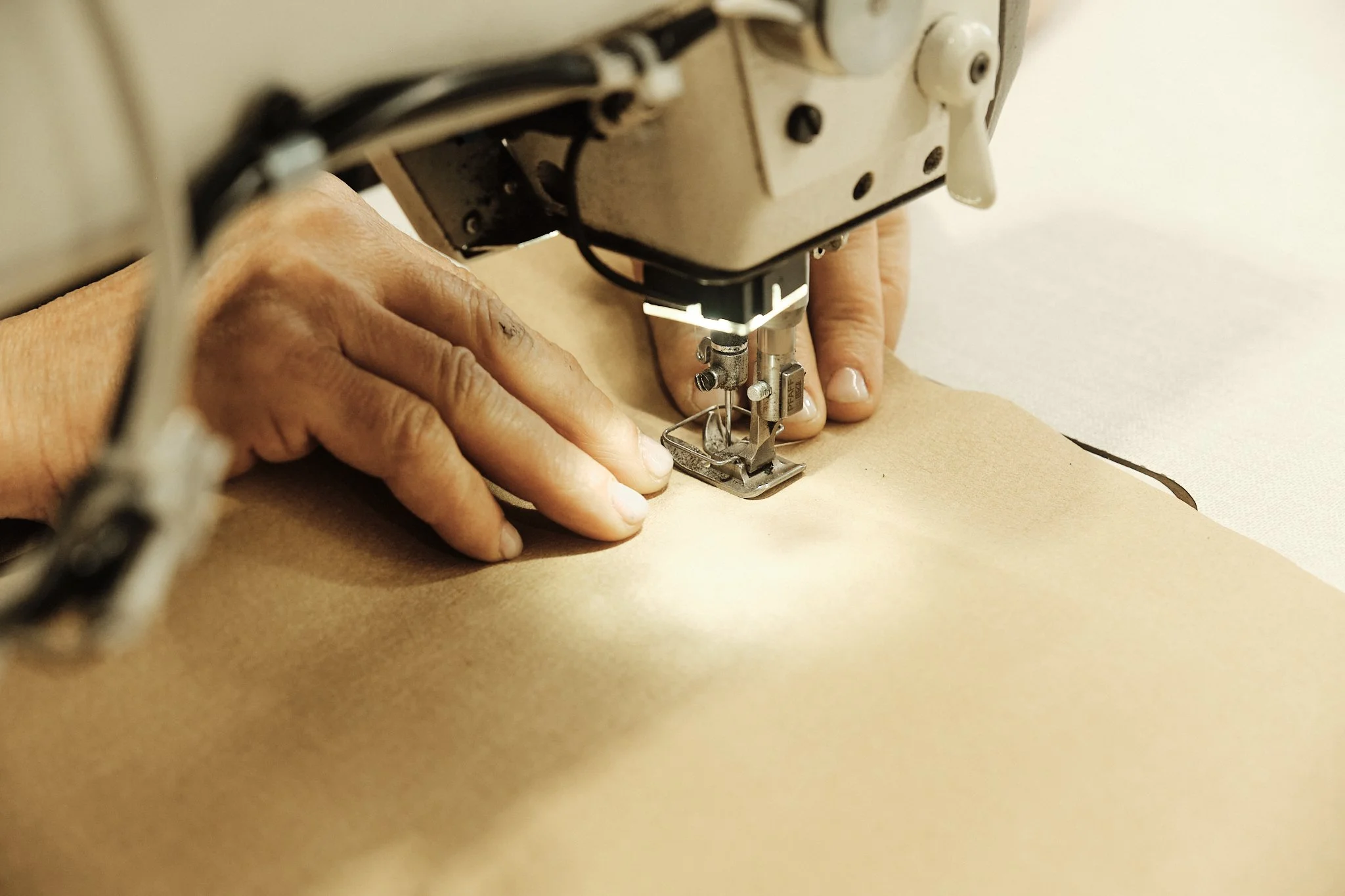 Une personne utilise une machine à coudre pour fabriquer du cuir ou du tissu