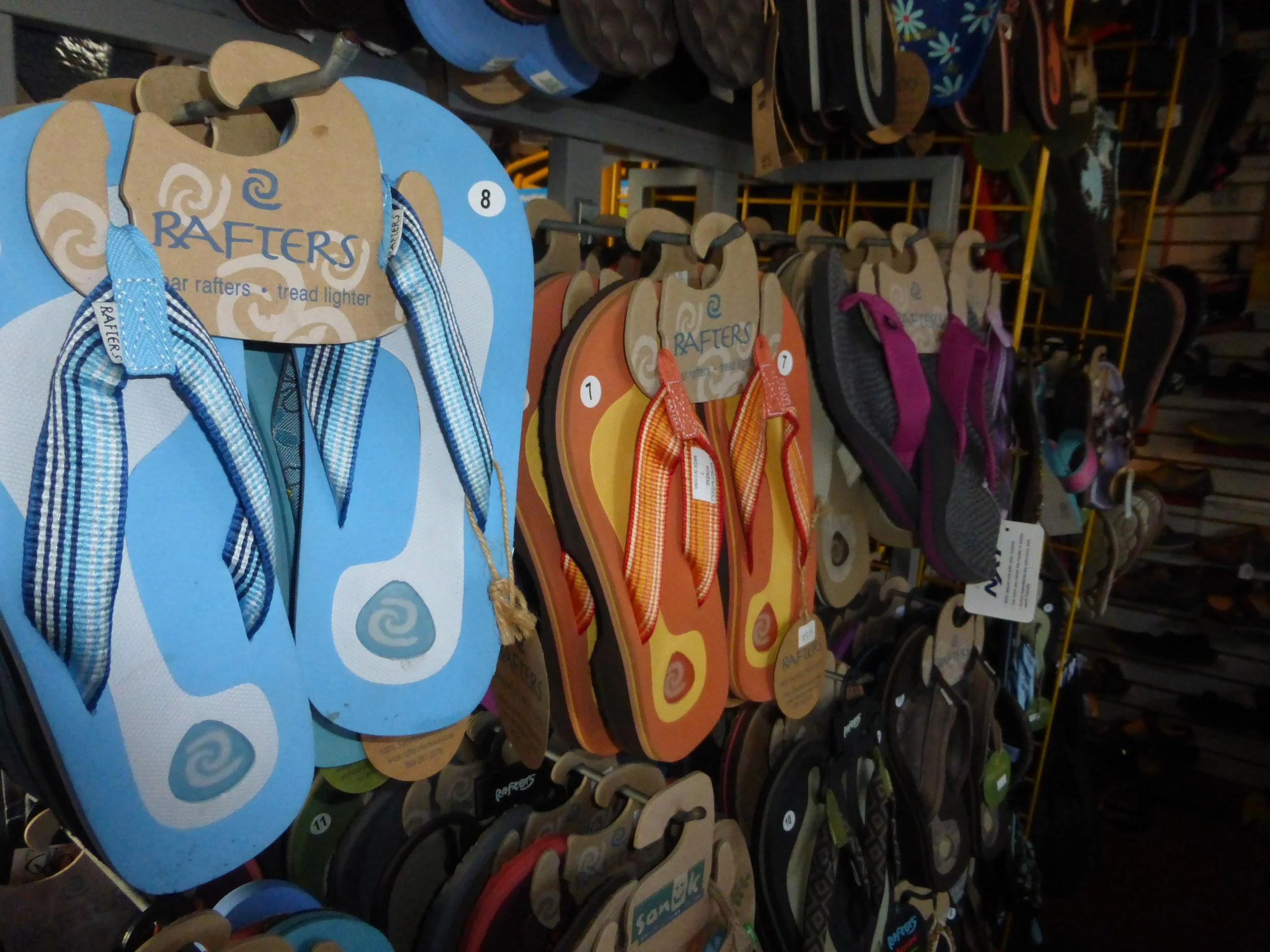 Assorted flip-flops displayed in a store. Reefs, Rainbows, Chacos