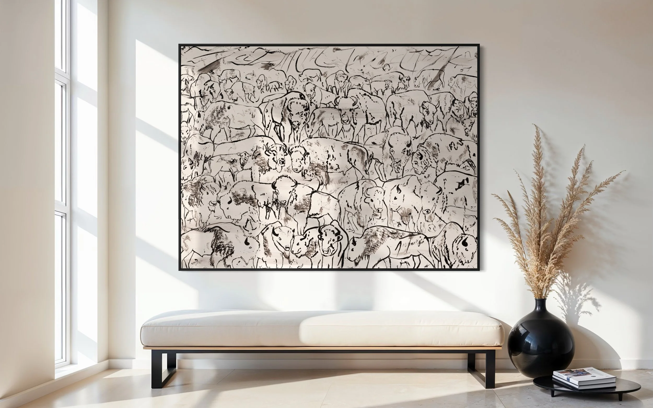 Modern living room with a large black and white animal sketch artwork on the wall, a white bench with black legs, a black vase with dried reeds, and sunlight streaming through large windows.