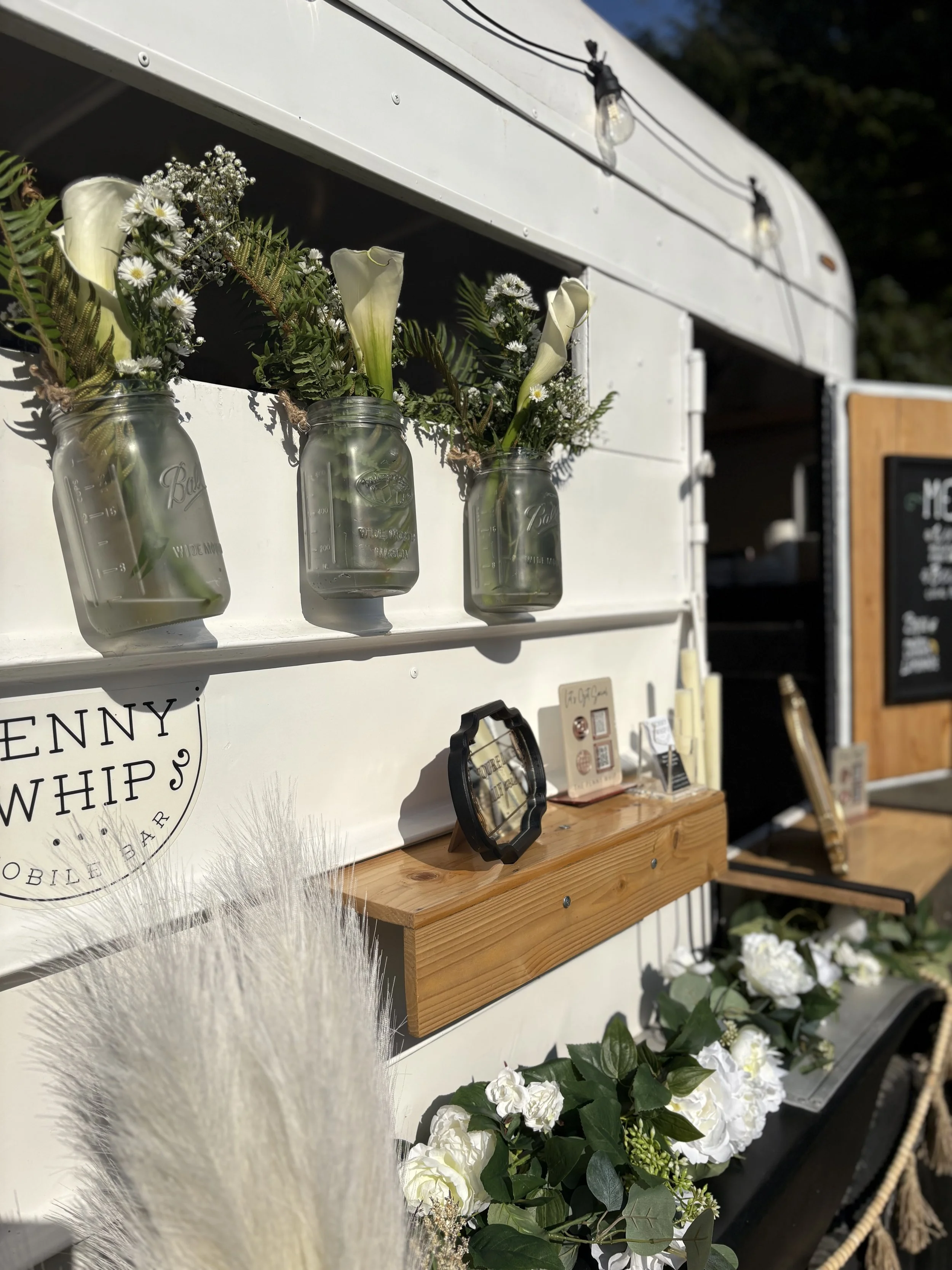 Wonderful flower arrangments at this beachside wedding event, floral on the wheel well. 