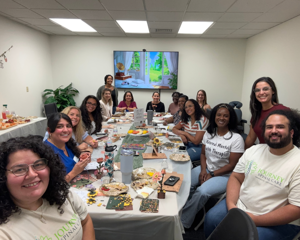 Group of healers sitting around table doing crafts.