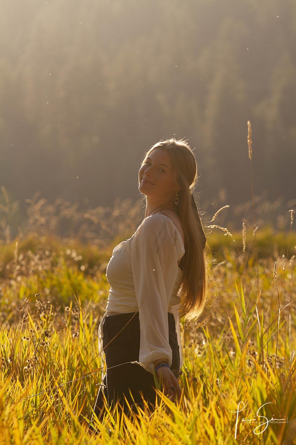 Senior girl at sunset in tall grass
