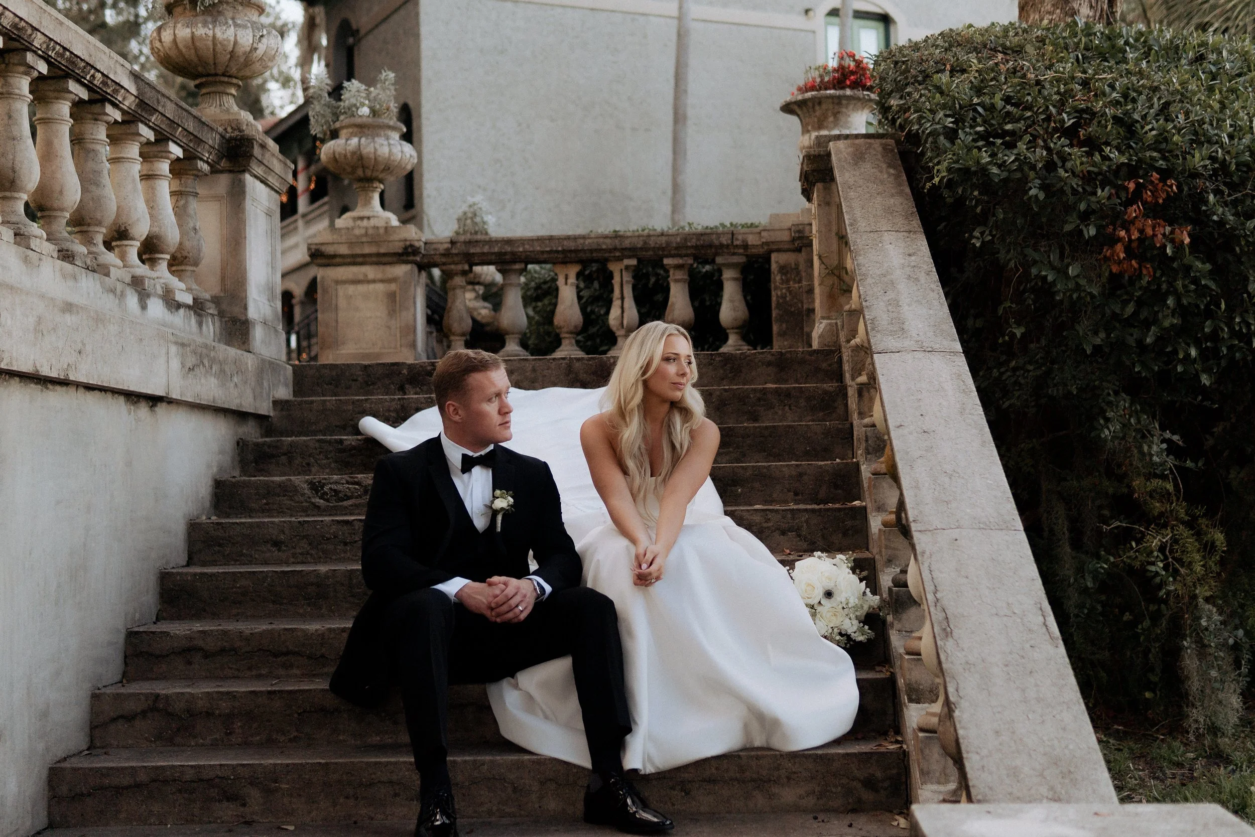 Beautiful couple look to the water on their wedding day after their first look.