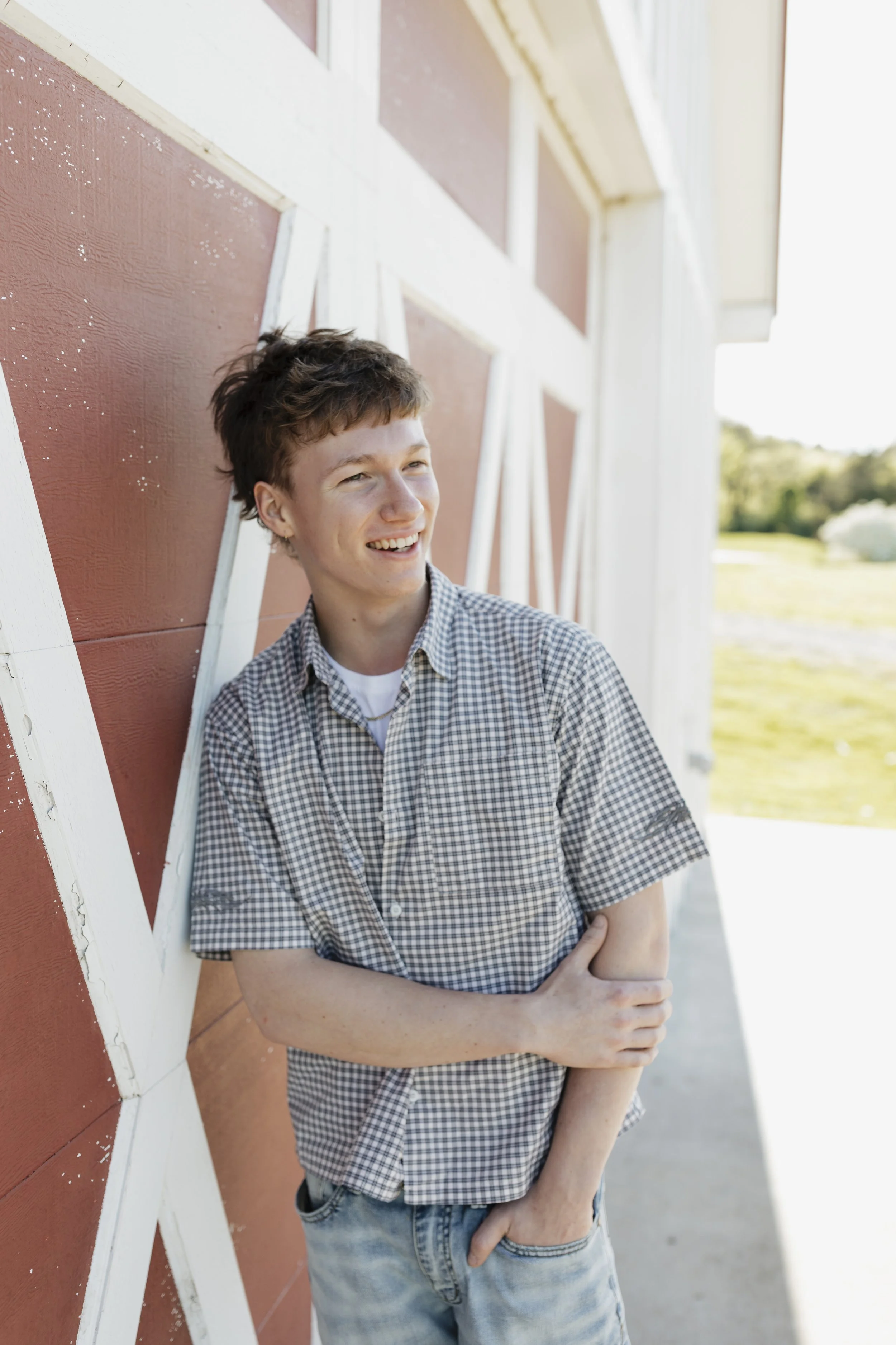 Sam in Brentwood smiling next to the barn at Smith Park
