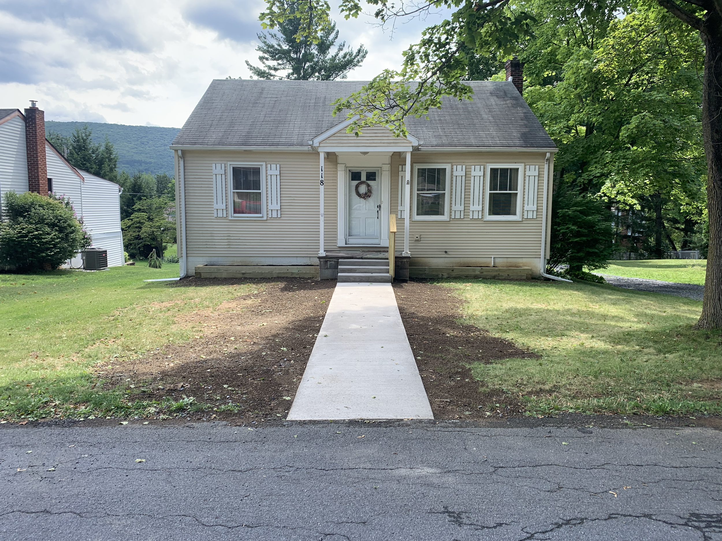 A new front concrete walkway and stairs.