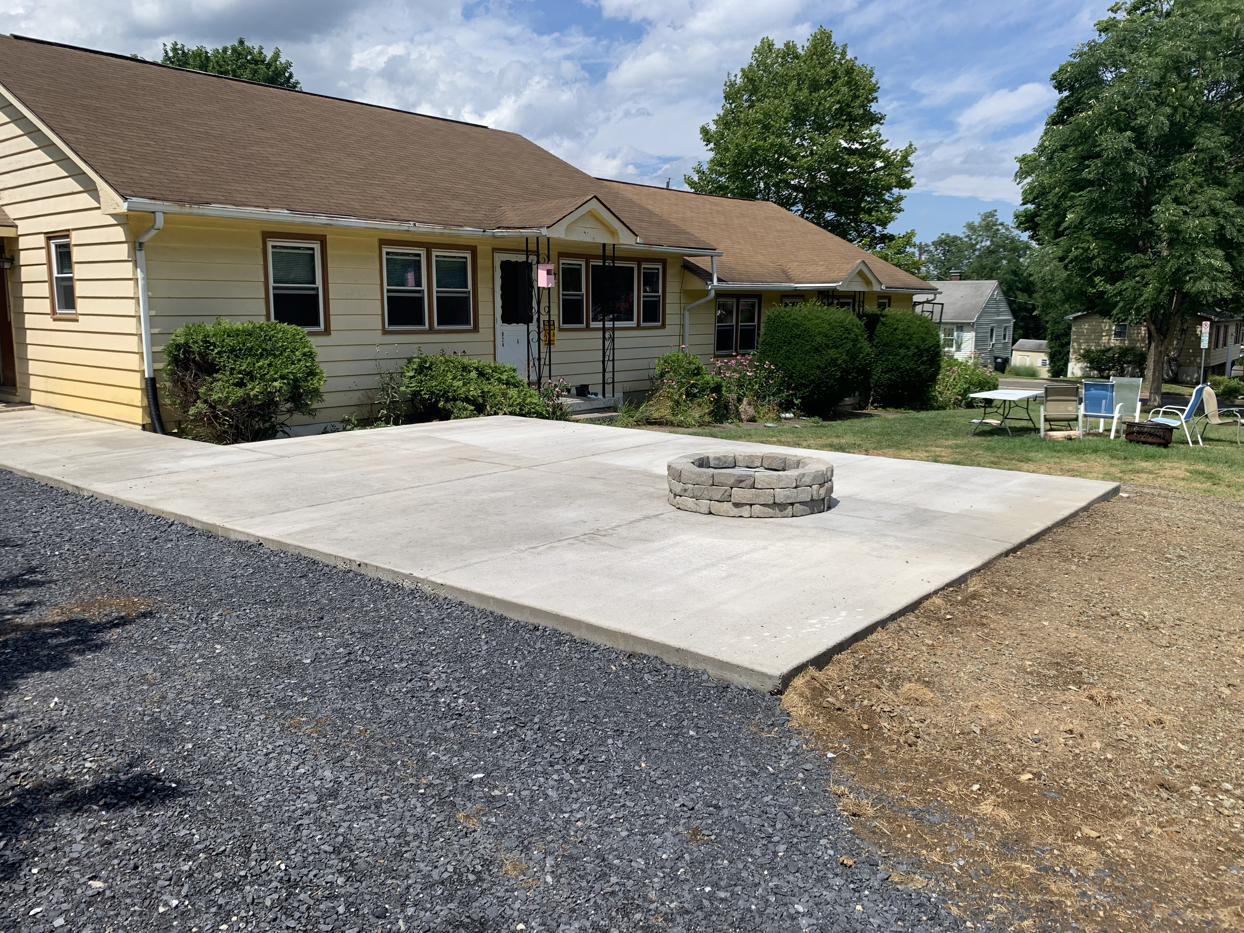 New concrete patio with custom fire pit.