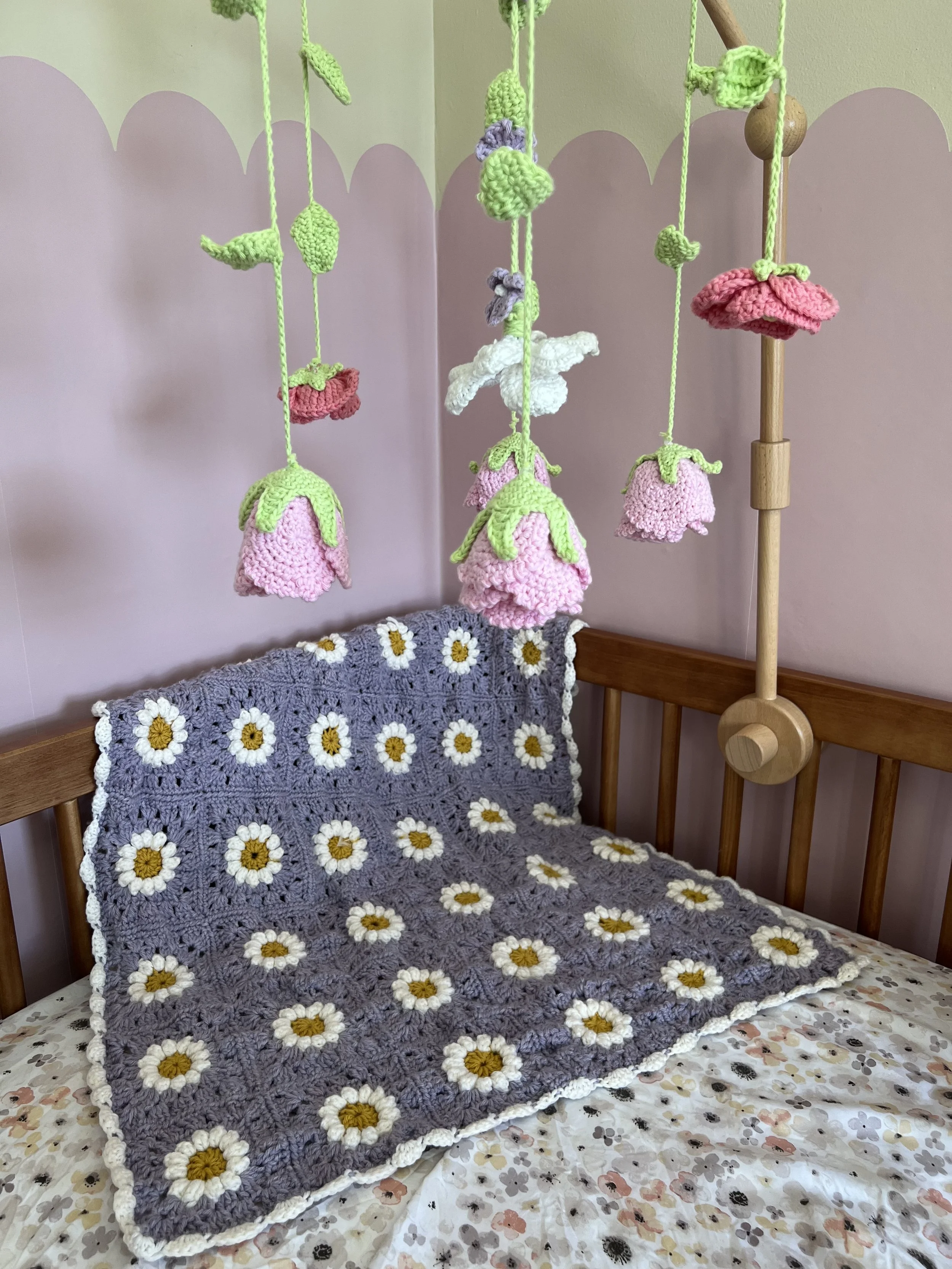 Crocheted quilt and crocheted flower mobile for a baby