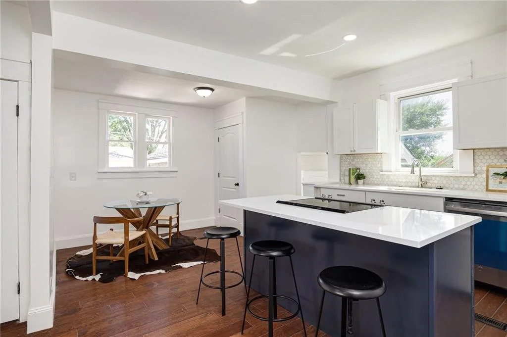 Modern kitchen interior with island, stools, and dining table
