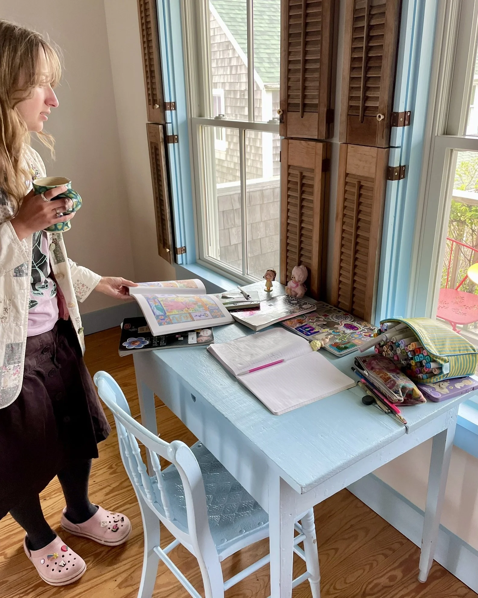 Saide looking at book on her table Room 9.jpeg