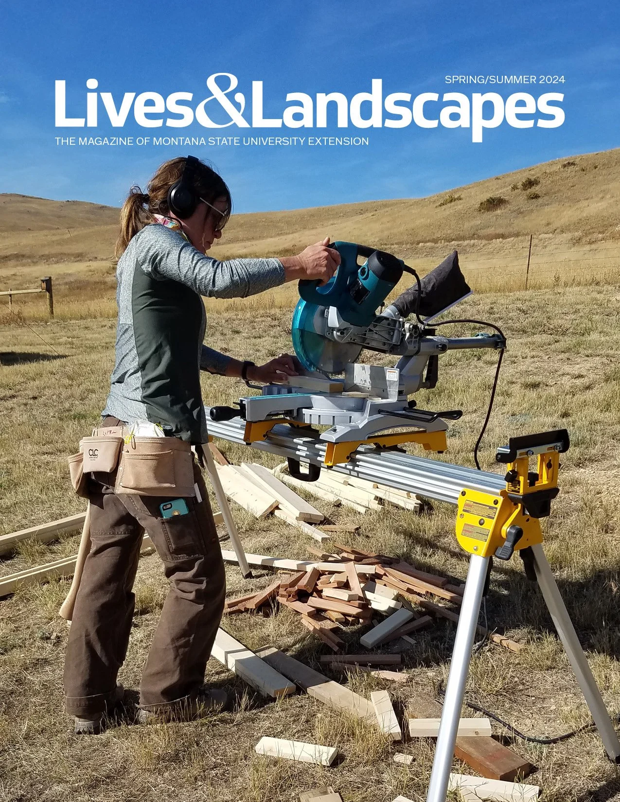 Woman chops trim wood with a chop saw in a field. 