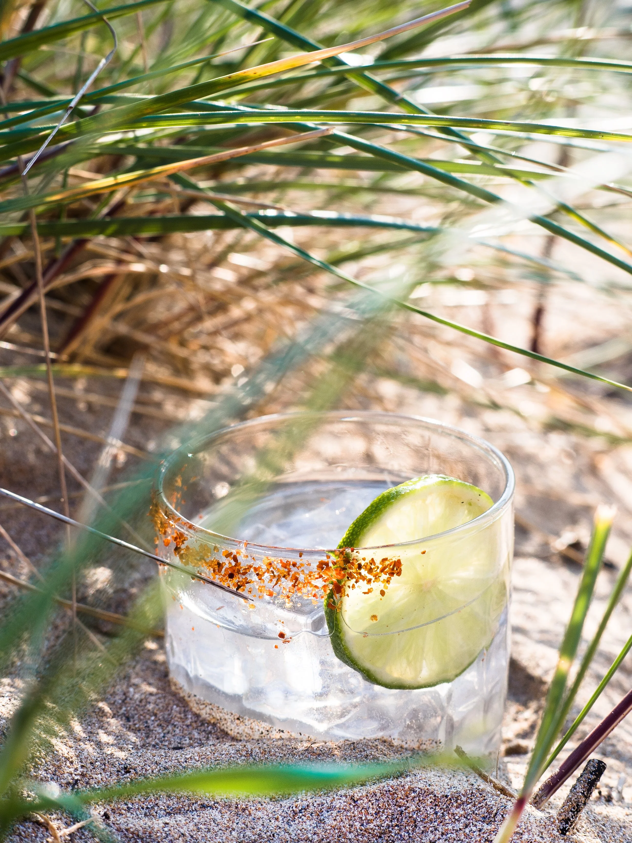 A coastal margarita made using atlantic distillery triple sec and enjoyed on the beach of the classic cornish coastline, garnished with lime and a smoked spice rim