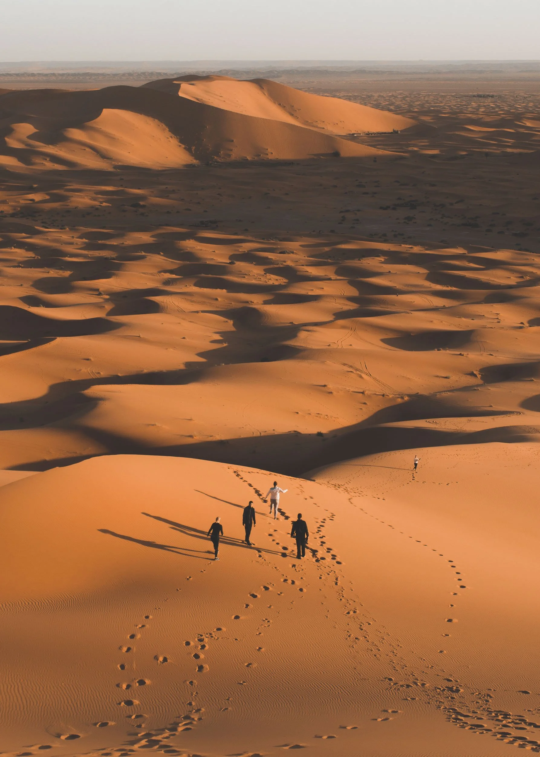 Climbing dunes at sunrise, Sahara Desert, Morocco