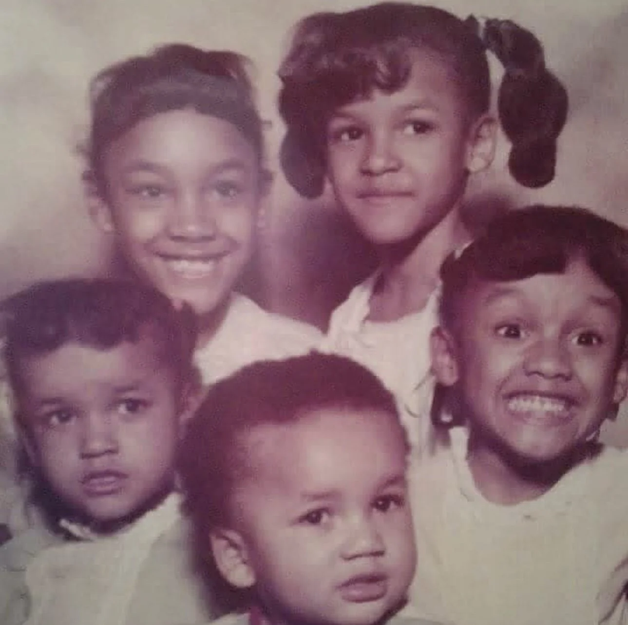 Black-and-white family portrait with young children, casual and warm, a moment preserved in early photography.