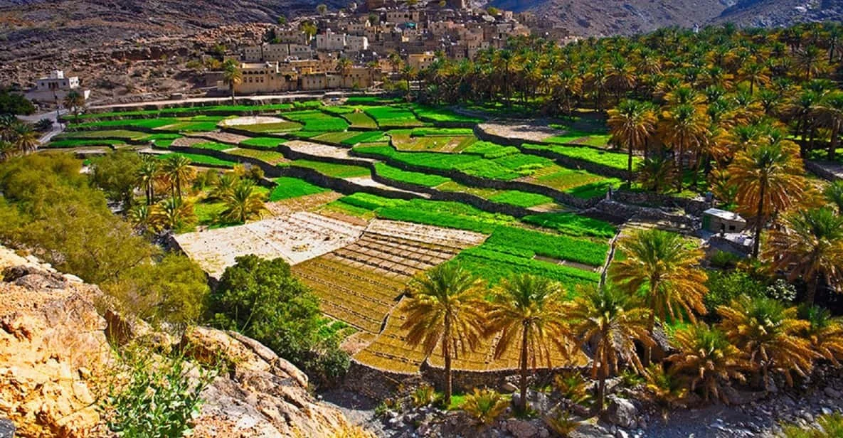Outdoor marketplace with pottery stalls, clay pots, and palm trees in a traditional Middle Eastern town.