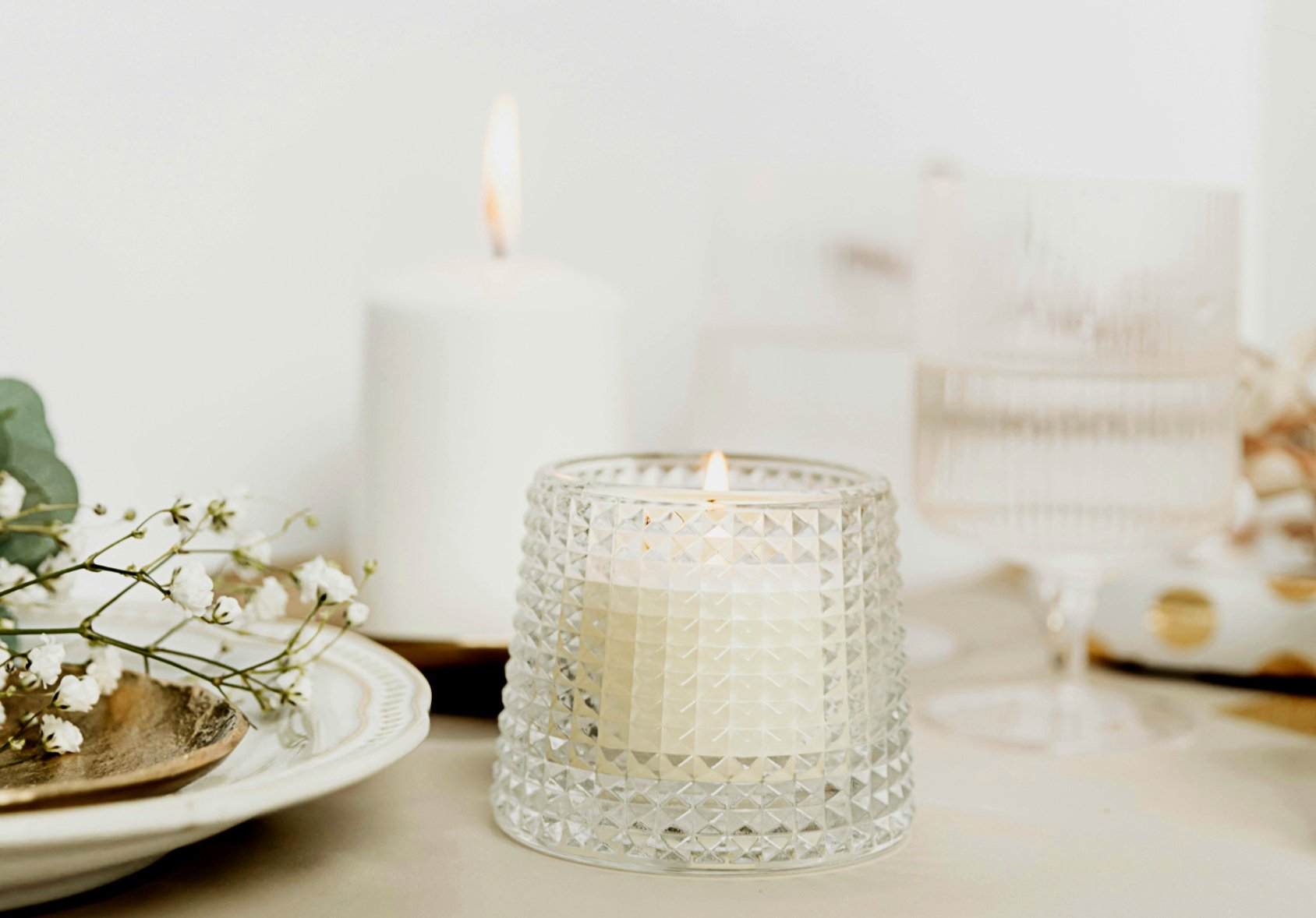 Close-up of a burning candle creating a warm, cosy dining atmosphere.