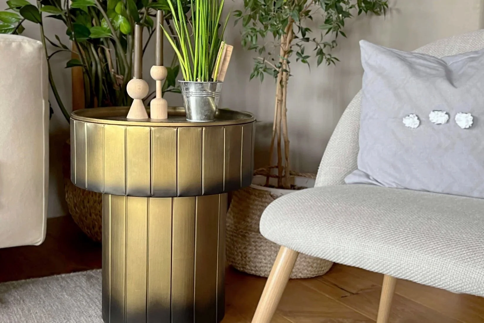 A circular brass side table featuring a discreet hidden storage compartment beneath the tabletop.