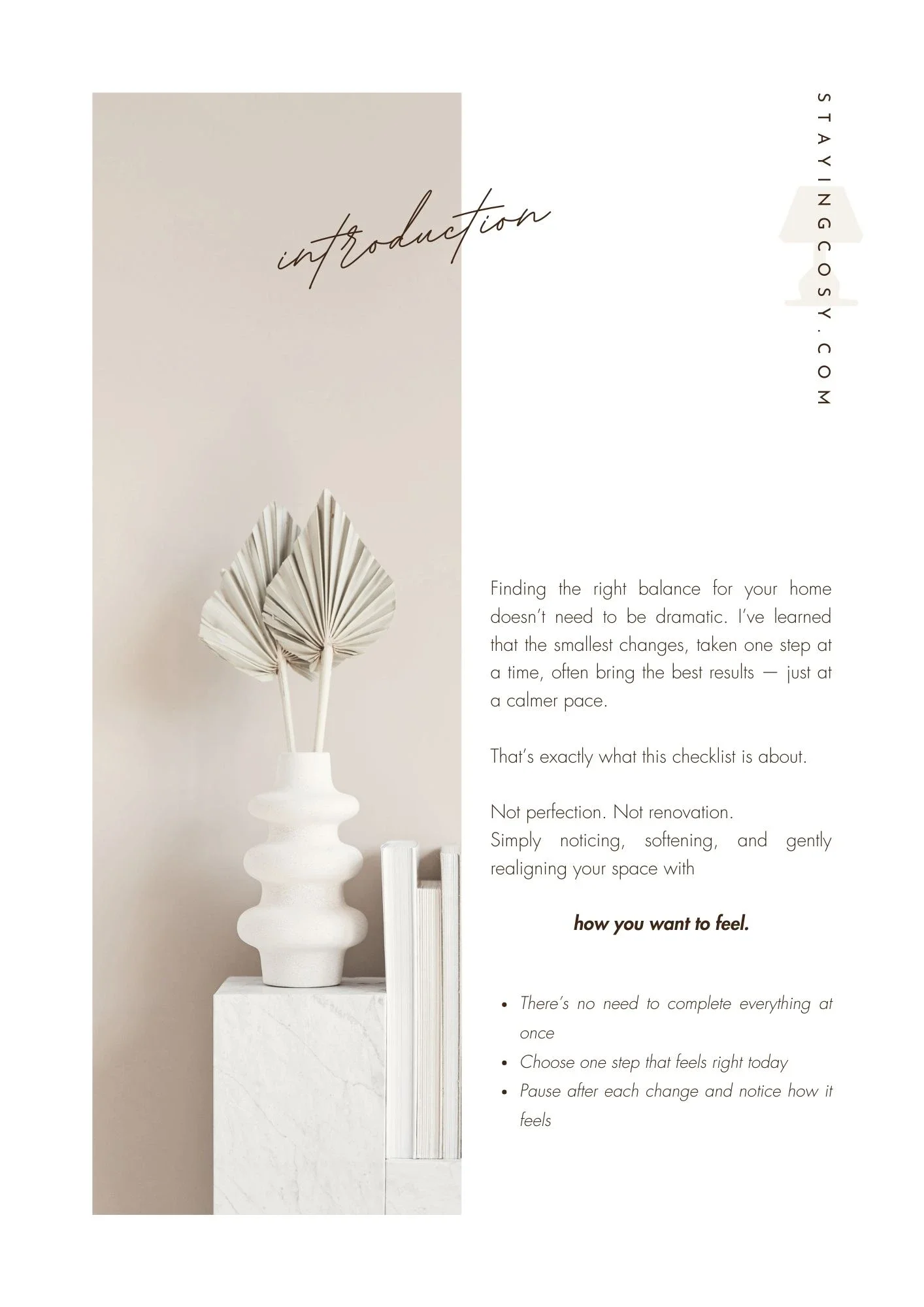 Minimalist interior decor with a white vase containing dried palm leaves, with text about home styling and a website URL.