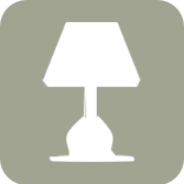 Silhouette of a table lamp on a greyish-green background