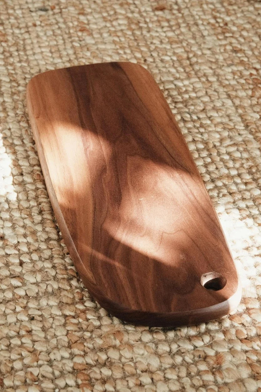 Wooden chopping board in direct South-facing sunlight, showing the sun as a natural sanitiser for the kitchen.