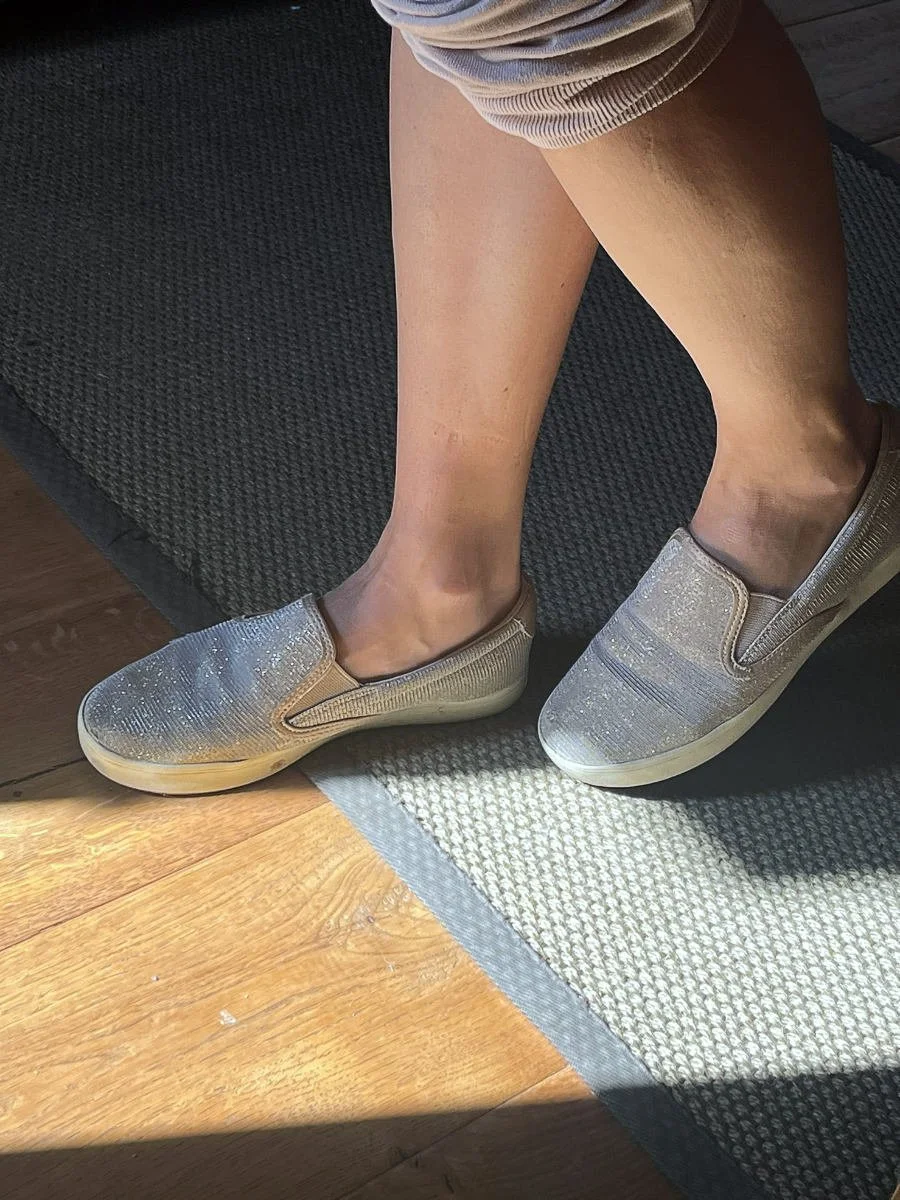 Close up view of feet walking over a room threshold demonstrating the tactile psychology of transitions in architecture